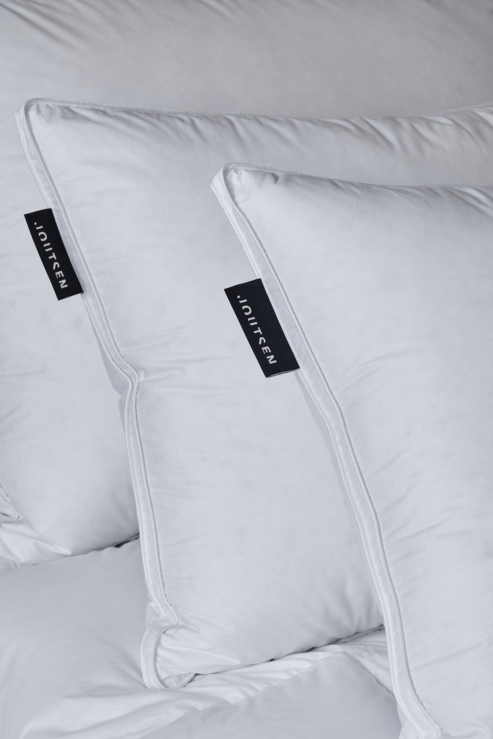 White down pillows with a black Joutsen-label.