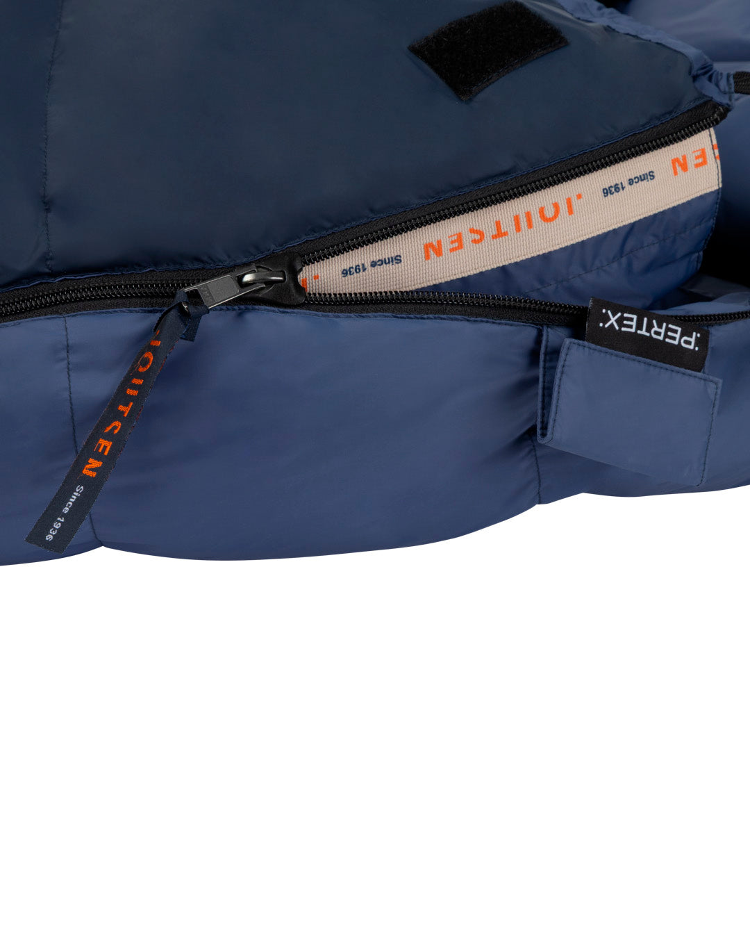 Close-up of a blue sleeping bag with visible brand logos on zippers and fabric.