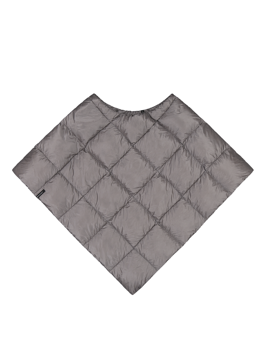 Grey, (color: Twilight grey) diamond-quilted Unelma down poncho. The poncho has a round neckline and flares out from the shoulders downwards, creating an angular silhouette. A small black brand label is located on the left edge.