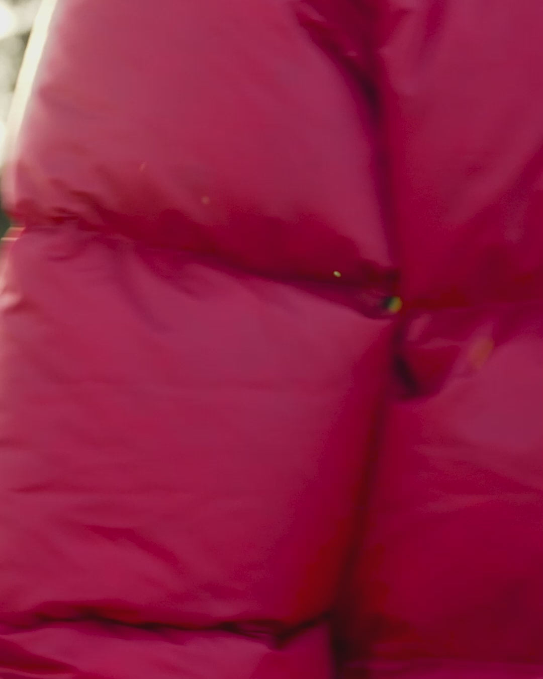 A woman walking away from camera in forest wearing a red (color name: Raspberry) long down coat. She has jeans and boots on.