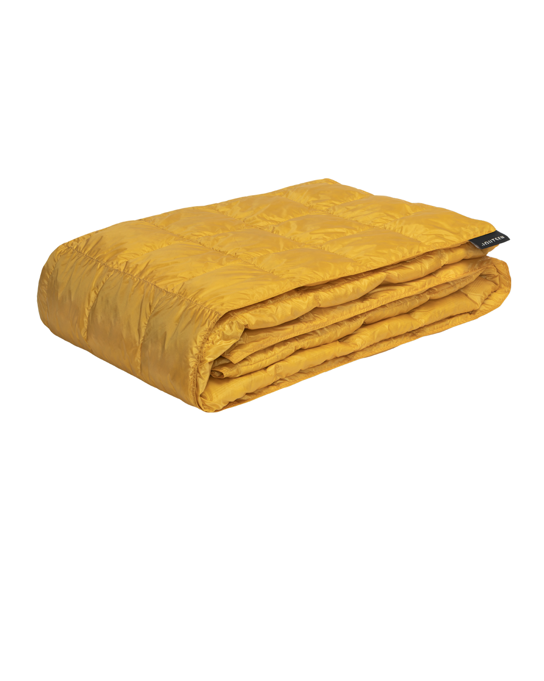 The yellow Kulkuri down blanket (color: Tuscan sun) is neatly folded, and its surface is decorated with stitched square quilting patterns.